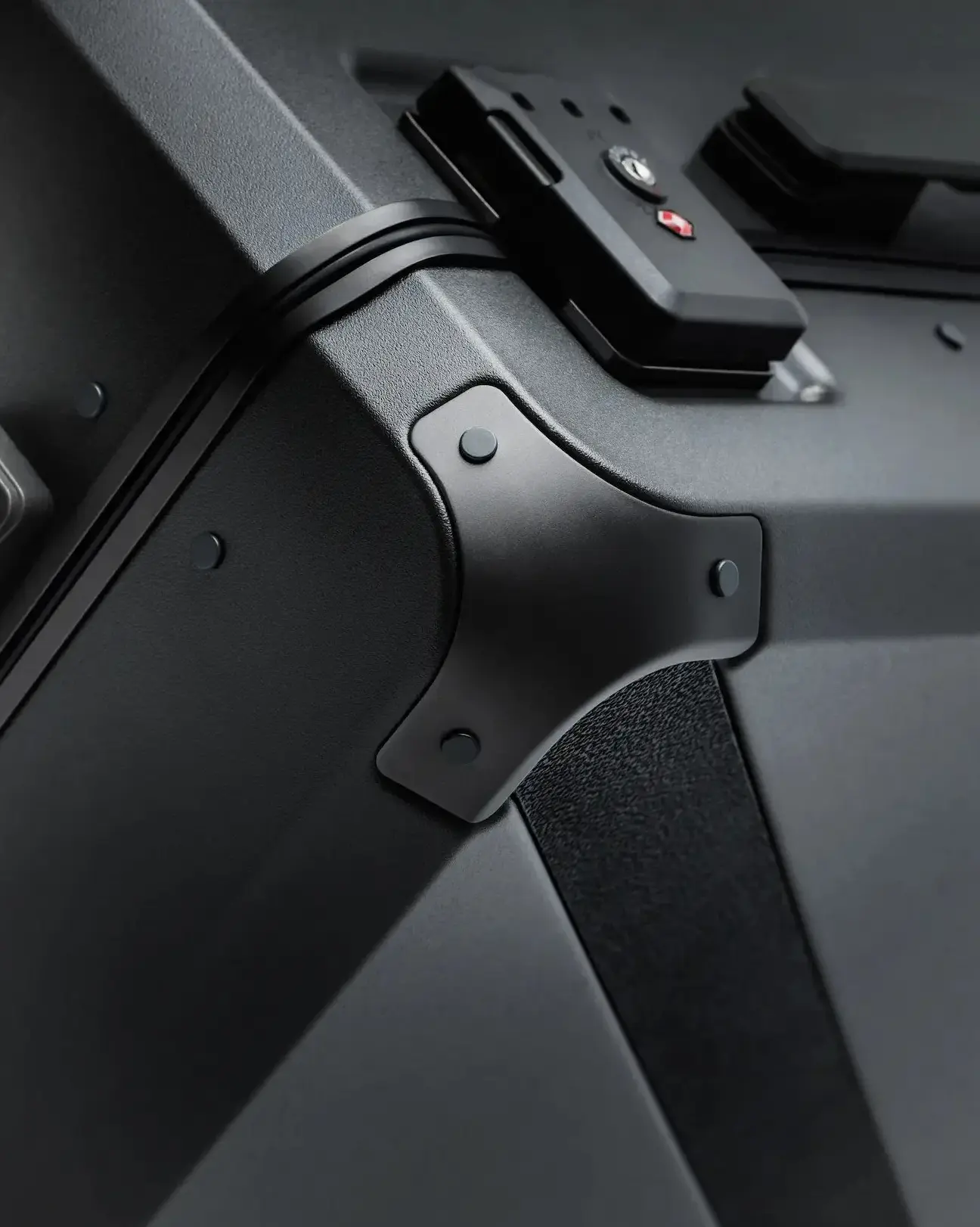 Detail of Armoir carry-on trunk showing reinforced aluminum corner and TSA-approved lock